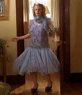 Molly komt, opzichtig gekleed, de kamer binnen.