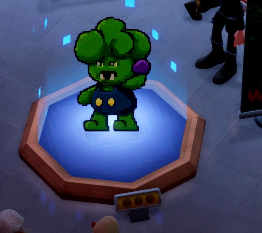 Een afbeelding van een Brorccoli, opgebouwd uit pixels, met vele kleine, vierkantige, blauwe partikels die rond het Museumstuk zweven. De Brorccoli is een groene monster-broccoli met broccolikrullen als hoofdhaar, gekleed in een donkerblauwe broek-met-bretels. Hij heeft een open mond met twee scherpe hoektanden, en staat op het punt een paars bolvormig projectiel te werpen.