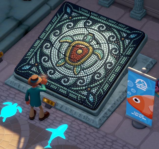 Bovenaanzicht van een enorme Wetlantische Mozaïek, waarop een Zeeschildpad afgebeeld staat. De Mozaïek wordt afgeborsteld door een Marine Expert; aan de rechterkant is een reclamevlag zichtbaar, met een oranje vis erop.