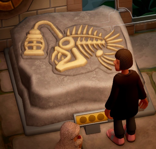 Een Bezoeker bekijkt een Lantern Fish Fossil. Onderaan is het hoofd van een Yeti-bezoeker nog net zichtbaar.