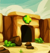 De ingang van een stenen grot. Boven de ingang ligt een horizontale stenen balk, met daaronder een groen kruis.